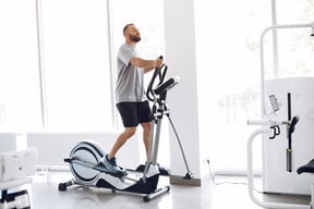 bearded-man-using-spin-bike-in-physiotherapy-room