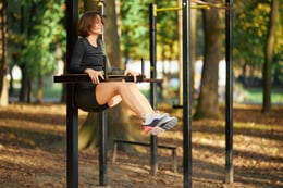 happy-woman-doing-fitness-exercises-on-fresh-air